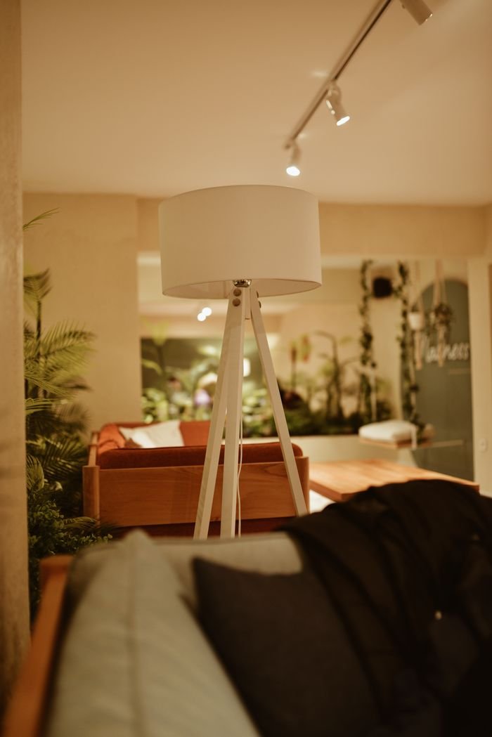 Stylish modern living room with a floor lamp and soft lighting, creating a cozy atmosphere.